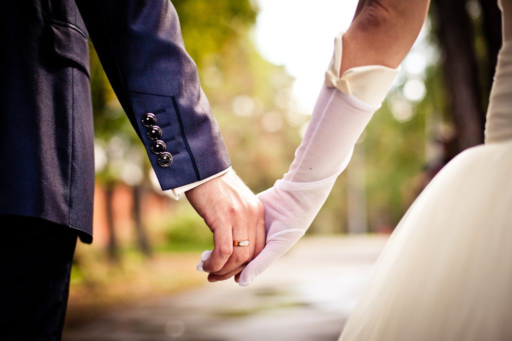 Newly Married couple holding hands