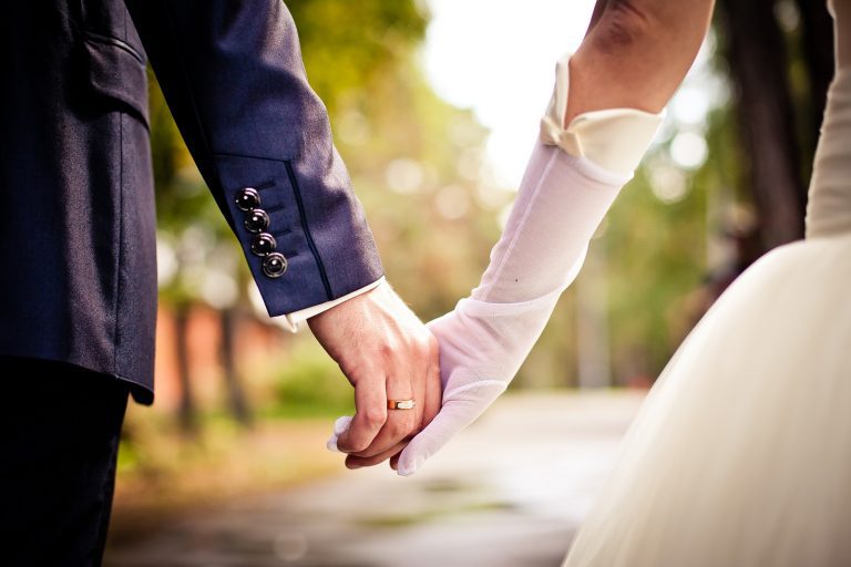 Newly Married Couple Holding Hands